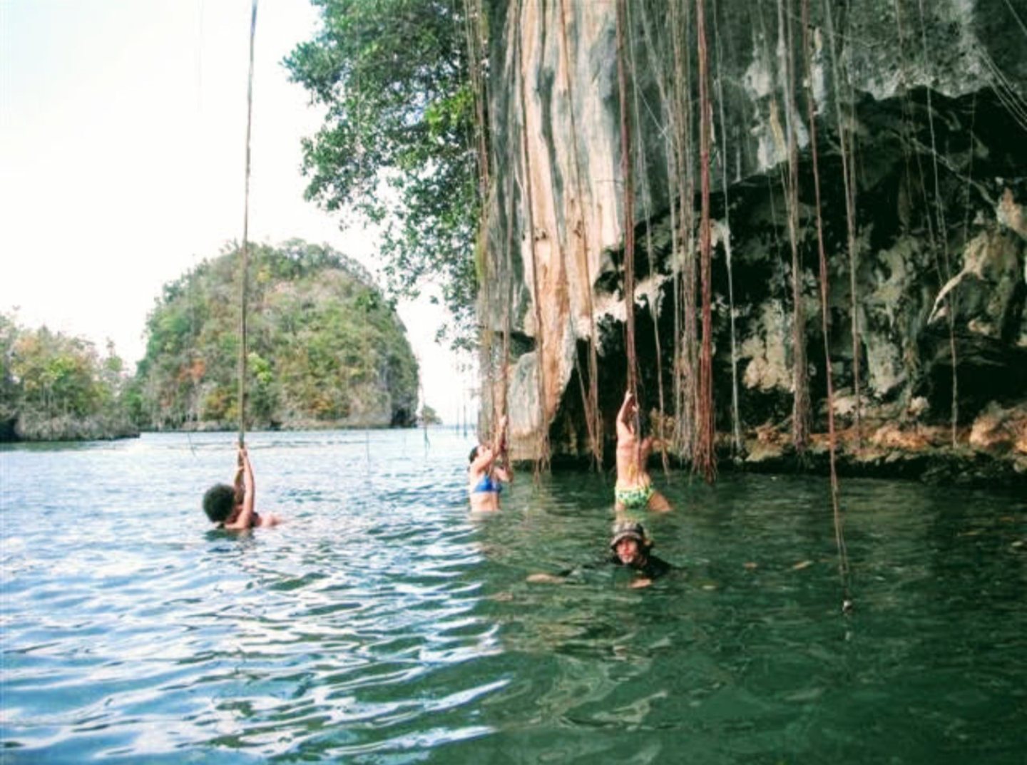 Un grupo nadando junto a una formación rocosa en Los Haitises